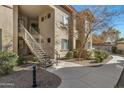 A building exterior with stairs and landscaped pathway leading to entrance and lush green landscape at 3330 S Gilbert Rd # 2021, Chandler, AZ 85286