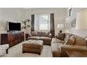 Comfortable living room with plush seating, media center, neutral carpet, and large window at 3330 S Gilbert Rd # 2021, Chandler, AZ 85286