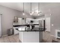 Bright kitchen showcases an island, stainless steel appliances, and pendant lighting at 4109 E Chambers St, Phoenix, AZ 85040