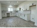 Bright kitchen featuring white cabinets, sleek black hardware, subway tile backsplash, and tile flooring at 4116 E Park St, Phoenix, AZ 85042