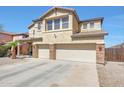 Elegant two-story home with desert landscaping, a three-car garage, and a welcoming facade at 4138 N 298Th Ln, Buckeye, AZ 85396