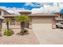 Well-maintained house showcasing a two-car garage, stone accents, and a landscaped front yard at 43828 W Roth Rd, Maricopa, AZ 85138
