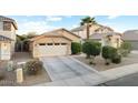 Inviting single-Gathering home with a well-manicured front yard, a two-car garage, and desert landscaping at 44355 W Oster Dr, Maricopa, AZ 85138