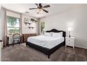 Bright bedroom with neutral tones, ceiling fan, and a large window offering natural light at 4495 E Woodside Way, Gilbert, AZ 85297