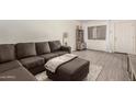 Comfortable living room with a gray sofa, ottoman, and a view of the building exterior at 520 N Stapley Dr # 181, Mesa, AZ 85203