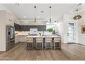 Modern eat-in kitchen with a large center island, stainless steel appliances, and hardwood floors at 5410 E Verde Ln, Phoenix, AZ 85018