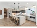Modern eat-in kitchen featuring a large center island with a waterfall countertop and stainless appliances at 5410 E Verde Ln, Phoenix, AZ 85018