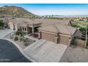 Expansive single-story home with a three-car garage, tile roof, desert landscaping and mountain views at 582 W Stirrup Ln, San Tan Valley, AZ 85143