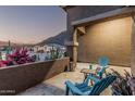 Cozy front patio featuring comfortable seating and scenic views of the surrounding desert landscape at 582 W Stirrup Ln, San Tan Valley, AZ 85143