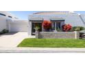 Charming home with well-maintained lawn, olive front door, and an attached garage at 6314 N 14Th St, Phoenix, AZ 85014