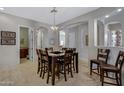 Spacious dining room showcases neutral paint, travertine floors, and an elegant chandelier at 6694 S Banning St, Gilbert, AZ 85298