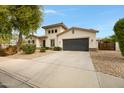 Charming two-story home with a spacious driveway, a neutral color palette, and beautiful curb appeal at 6694 S Banning St, Gilbert, AZ 85298