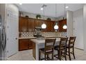 Modern kitchen features stainless steel appliances, a white quartz island, and dark wood cabinets at 6694 S Banning St, Gilbert, AZ 85298