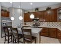 Gourmet kitchen features stainless steel appliances, a white quartz island, and dark wood cabinets at 6694 S Banning St, Gilbert, AZ 85298