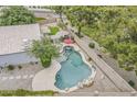 Aerial view of a backyard pool with patio furniture and rock waterfall at 720 W Gail Ct, Gilbert, AZ 85233