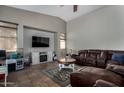 Cozy living room with tile floors, a ceiling fan, and a comfortable brown leather sofa at 7424 W Pioneer St, Phoenix, AZ 85043