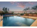 Backyard pool with view of golf course, beautiful desert landscape and privacy fence at 766 E Taylor Trl, San Tan Valley, AZ 85143