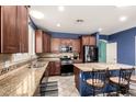 Well-equipped kitchen featuring stainless steel appliances, granite countertops, and a kitchen island with seating at 81 E Rock Wren Dr, San Tan Valley, AZ 85143