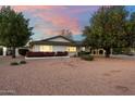 Attractive single-story home featuring desert landscaping, a covered parking area, and colorful flower beds at 8228 E Oak St, Scottsdale, AZ 85257