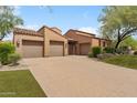 Charming single-story home featuring a well-manicured front yard and a convenient three-car garage at 8512 E Gilded Perch Dr, Scottsdale, AZ 85255
