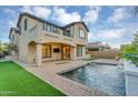 Beautiful backyard featuring a sparkling pool and well-manicured lawn at 880 E Wimpole Ave, Gilbert, AZ 85297