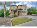 Charming two-story home showcasing well-manicured landscaping and inviting stone accents at 880 E Wimpole Ave, Gilbert, AZ 85297