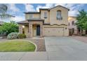 Inviting two-story home boasts desert landscaping, a spacious driveway, and an attached garage at 880 E Wimpole Ave, Gilbert, AZ 85297