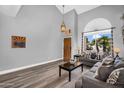Open-concept living area featuring high ceilings, wood-look floors, and a neutral color palette at 9225 E Pine Valley Rd, Scottsdale, AZ 85260