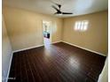 Bedroom with hardwood floors, ceiling fan, and an ensuite bathroom at 1007 W Fairmount Ave, Phoenix, AZ 85013