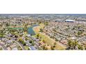 High aerial view of the community showcasing lush green spaces, a lake, and residential areas at 11627 S Jokake St, Phoenix, AZ 85044