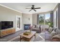 Comfortable living room features a fireplace, ceiling fan, and access to outdoor balcony at 19777 N 76Th St # 3238, Scottsdale, AZ 85255