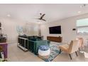 Comfortable living room with modern decor, a ceiling fan, and a large area rug at 19875 W Badgett Ln, Litchfield Park, AZ 85340