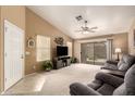 Bright living room featuring neutral carpet, sliding glass doors, ceiling fan and comfortable seating at 20609 N 103Rd Dr, Peoria, AZ 85382