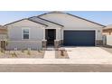 Attractive single-story home featuring desert landscaping and a secure gated entry at 37111 W Parador Ln, Maricopa, AZ 85138