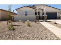 Inviting front yard with desert landscaping and a charming gated entrance at 37111 W Parador Ln, Maricopa, AZ 85138