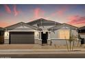 Inviting exterior view of home with garage, showcasing its modern design and attractive landscaping at 4032 S 176Th Dr, Goodyear, AZ 85338