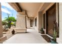 Covered front porch with columns leads to the decorative front door at 5744 E Hedgehog Pl, Scottsdale, AZ 85266