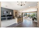 Open-concept living room with tiled floors, neutral paint, and seamless flow to dining and office spaces at 5744 E Hedgehog Pl, Scottsdale, AZ 85266