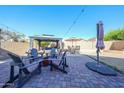 Spacious backyard with brick patio, gazebo, and seating area perfect for entertaining at 14912 W Lamoille Dr, Surprise, AZ 85374
