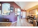 Inviting foyer with tile flooring, decorative arches, and views into other rooms at 14912 W Lamoille Dr, Surprise, AZ 85374