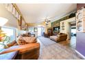 Cozy living room featuring tile floors, ceiling fan, and ample natural light at 14912 W Lamoille Dr, Surprise, AZ 85374