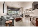 Open-concept living room with fireplace, dining area and tiled floors at 15148 N 100Th Pl, Scottsdale, AZ 85260