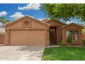Cozy single-story home featuring a two-car garage and low-maintenance landscaping in a tidy front yard at 1905 E Palomino Dr, Gilbert, AZ 85296