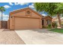 Well-maintained single-story home with a two-car garage, concrete driveway, and low water use landscaping at 1905 E Palomino Dr, Gilbert, AZ 85296