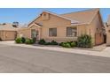 Street view of a tan single-Gathering home with manicured bushes, window box, and a side gate at 2039 W Ronald Rd, Phoenix, AZ 85029