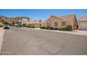 Street view of a tan single-Gathering home with manicured bushes and mountain backdrop at 2039 W Ronald Rd, Phoenix, AZ 85029