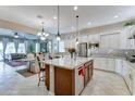 Bright and airy kitchen with a large island, granite countertops, stainless steel appliances, and ample cabinet space at 2087 N Park St, Buckeye, AZ 85396