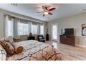 Serene bedroom features a ceiling fan, wood floors, large windows with natural light and a private exterior door at 2087 N Park St, Buckeye, AZ 85396