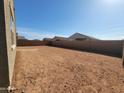 Large, undeveloped backyard awaiting your personal touch and landscaping ideas at 322 S San Christo Ln, Casa Grande, AZ 85194