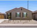 Charming single-story home featuring a red tile roof, desert landscaping, and shuttered windows at 322 S San Christo Ln, Casa Grande, AZ 85194
